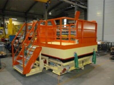 Mobile lifting platform in orange with stairs